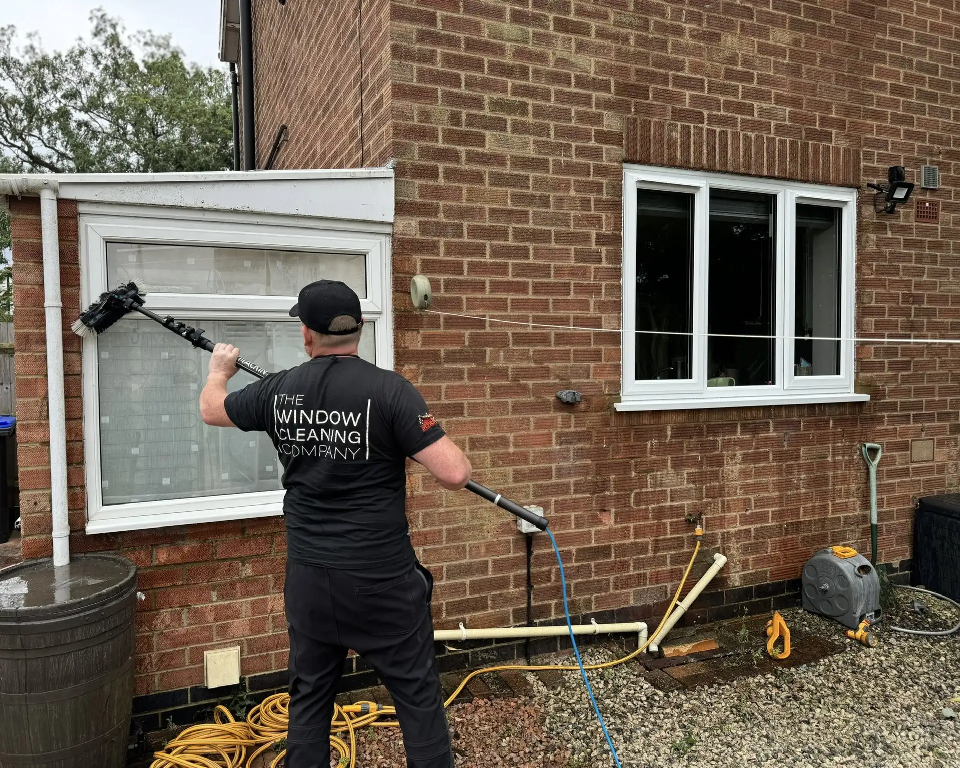 Window cleaner using the Thermo Pure reach and wash system at a domestic property in Northampton